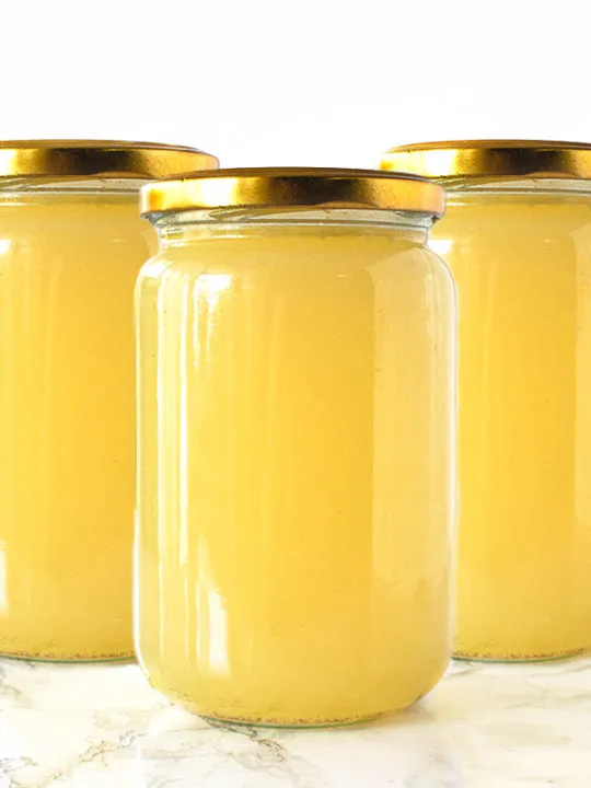 Chicken Wing Broth in jars on a white marble counter