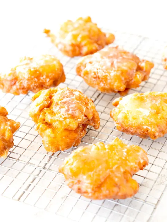 Dairy free apple fritters on a cooling wrack