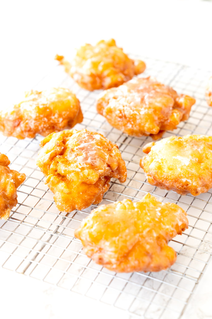 Dairy free apple fritters on a cooling wrack