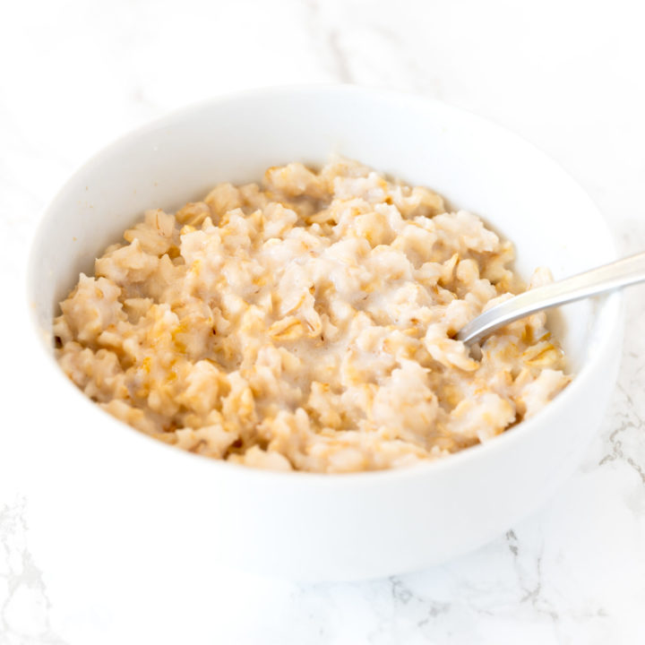 oatmeal in a white bowl on a white marble counter