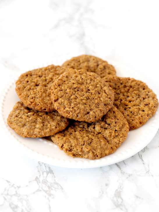 oatmeal cookies on a white plate on a white marble counter