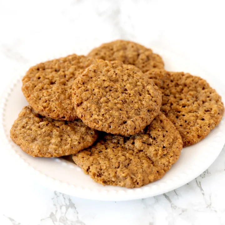 oatmeal cookies on a white plate on a white marble counter